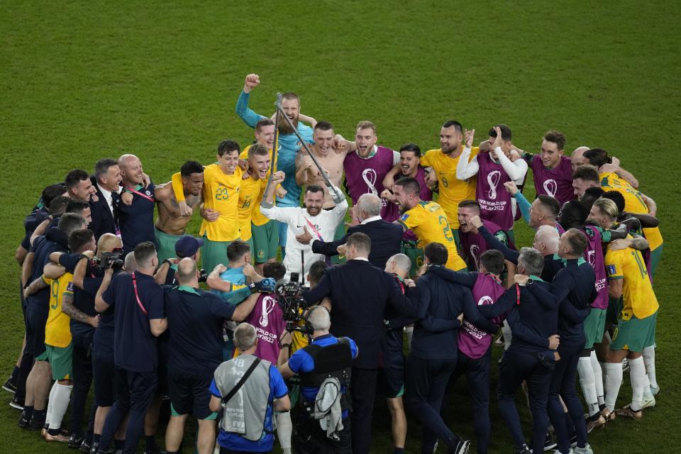 Australia's players celebrate winning 1-0 at the end of the World Cup group D soccer match between Australia and Denmark, at the Al Janoub Stadium in Al Wakrah, Qatar, Wednesday, Nov. 30, 2022. (AP Photo/Themba Hadebe)