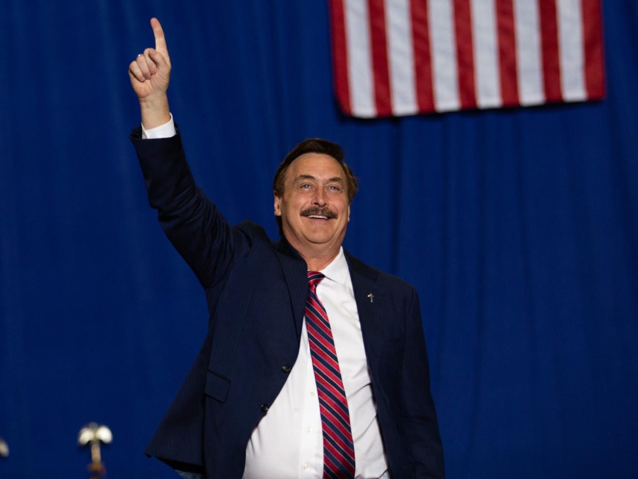 CEO of MyPillow Mike Lindell waves to the crowd before he speaks during a Save America rally on October 1, 2022 in Warren, Michigan.