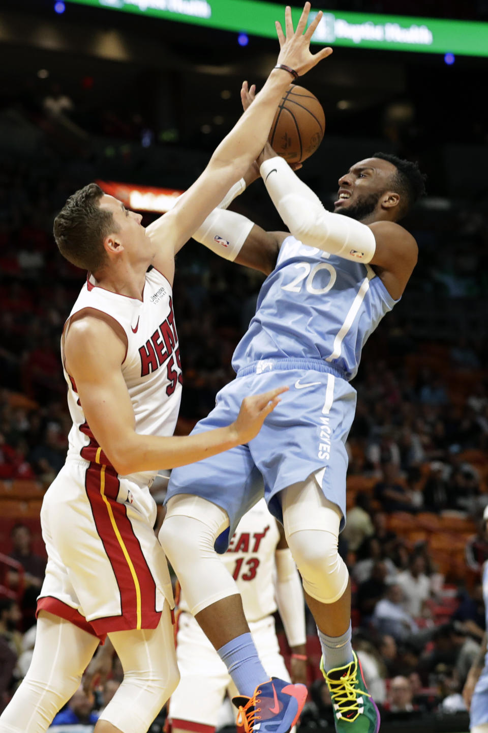 Minnesota Timberwolves guard Josh Okogie (20) attempts a shot against Miami Heat guard Duncan Robinson (55) during the first half of an NBA basketball game, Wednesday, Feb. 26, 2020, in Miami. (AP Photo/Wilfredo Lee)