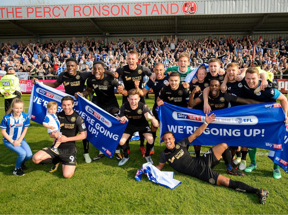 Wigan Athletic celebrate their promotion to the second tier: Rex Features