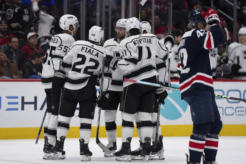 Los Angeles Kings left wing Kevin Fiala (22) is congratulated by teammates after scoring during the second period of an NHL hockey game against the Washington Capitals in Washington, Sunday, Jan. 7, 2024. (AP Photo/Manuel Balce Ceneta)