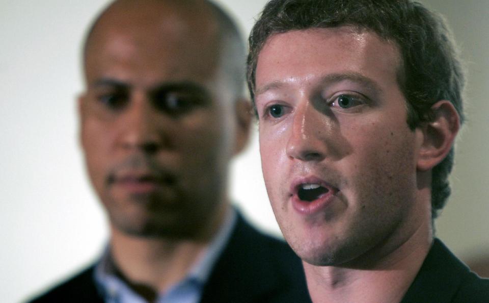 FILE - In this Sept. 25, 2010 file photo, Mark Zuckerberg, right, founder and CEO of Facebook talks about his donation of $100 million to help Newark public schools during a news conference in Newark, N.J. With Zuckerberg is Newark mayor Cory Booker and N.J. Gov. Chris Christie, not in picture. More than three years after Zuckerberg committed $100 million toward remaking Newark’s struggling schools, the district is engulfed in a dispute over proposed large-scale teacher layoffs that is threatening to derail wider reform efforts. (AP Photo/Rich Schultz)