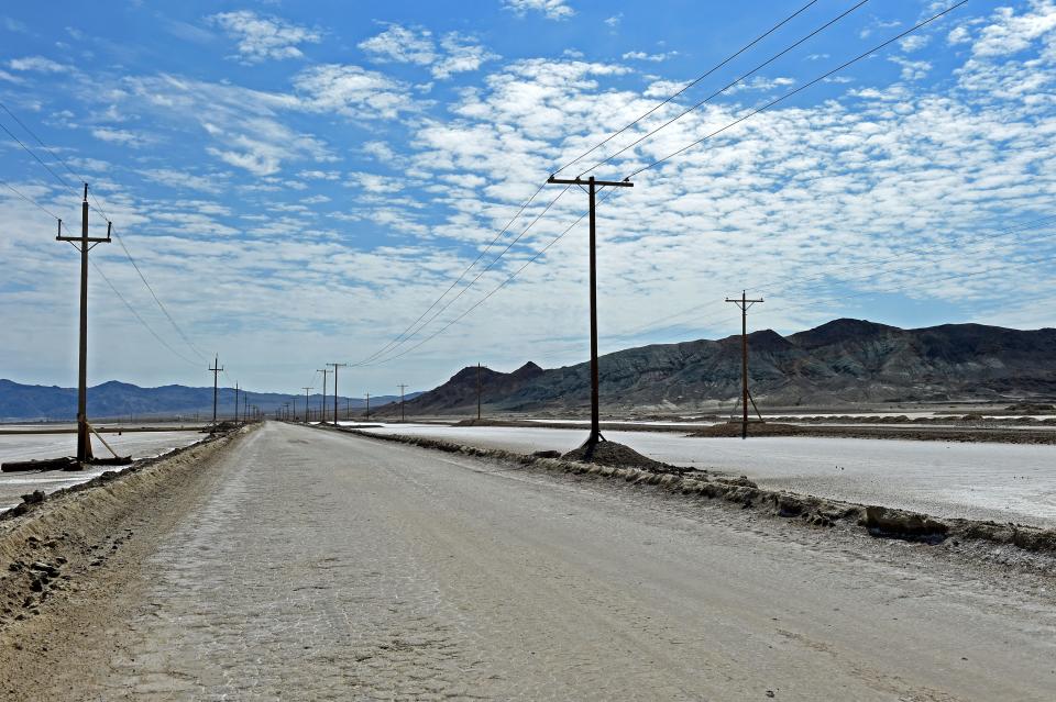 A dirt road runs between lithium evaporation pods owned by Albemarle Corporation in Silver Peak, Nevada.