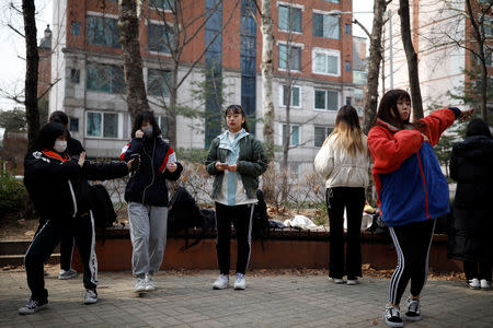 Nao Niitsu, 19, college freshman from Tokyo, who wants to be a K-pop star, and other Japanese children warm up for an audition at a park in Seoul, South Korea, March 15, 2019. REUTERS/Kim Hong-Ji