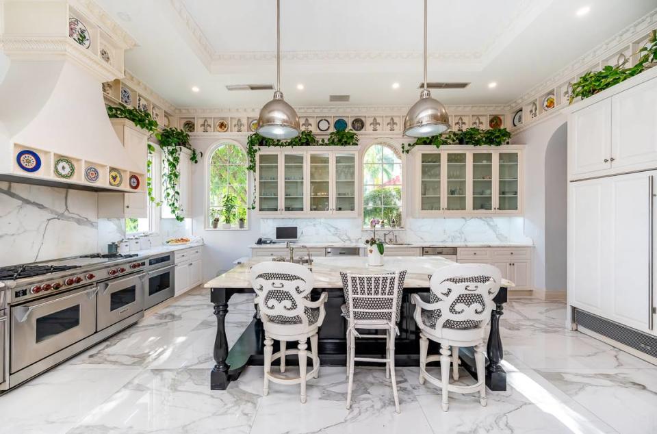 The Alarcón home features a gourmet kitchen, pictured above, with double gas ovens and stoves, marble floors and countertops, and adjacent breakfast room. Jorge Chao/ONE Sotheby's International Realty