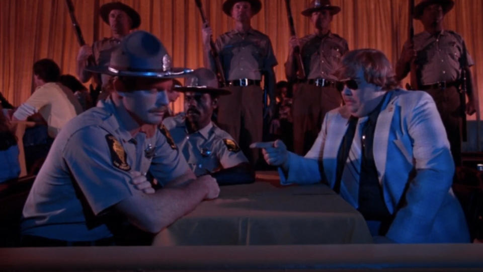 Steven Williams, Armand Cerami, and John Candy in The Blues Brothers