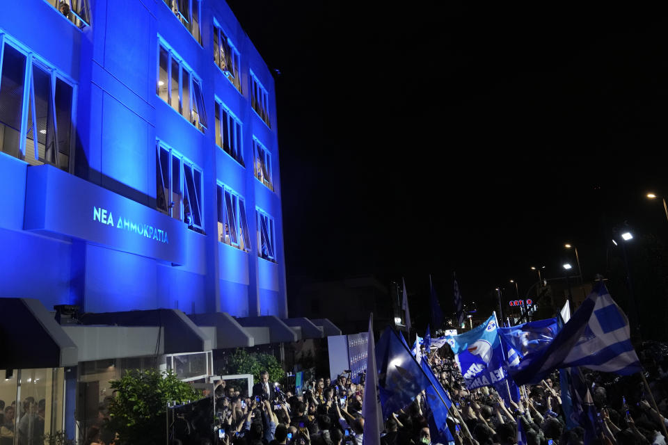 Supporters of Greece's Prime Minister and leader of New Democracy Kyriakos Mitsotakis gather at the party headquarters in Athens, Greece, Sunday, May 21, 2023. The conservative party of Greek Prime Minister Kyriakos Mitsotakis has won a landslide election but without enough parliamentary seats to form a government. (AP Photo/Thanassis Stavrakis)