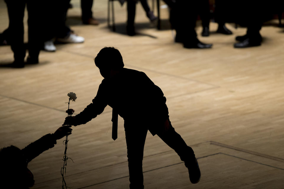 <p>Flamenco guitarist Paco de Lucía’s son Diego receives a flower to place on his father’s coffin during a wake at the National Auditorium in Madrid, Feb. 28, 2014. (AP Photo/Andres Kudacki) </p>