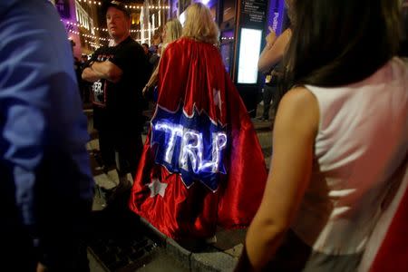 An attendee wearing a Trump cape exits the arena of the Republican National Convention in Cleveland, Ohio, U.S., July 22, 2016. REUTERS/Jim Urquhart