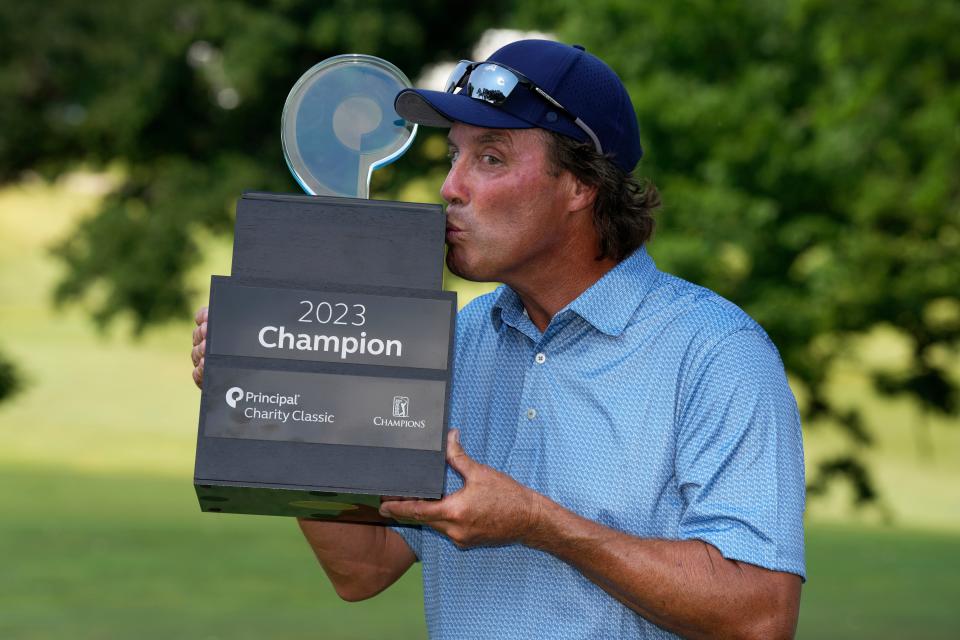 Stephen Ames kisses the trophy after winning the Champions Tour Principal Charity Classic golf tournament on June 4.