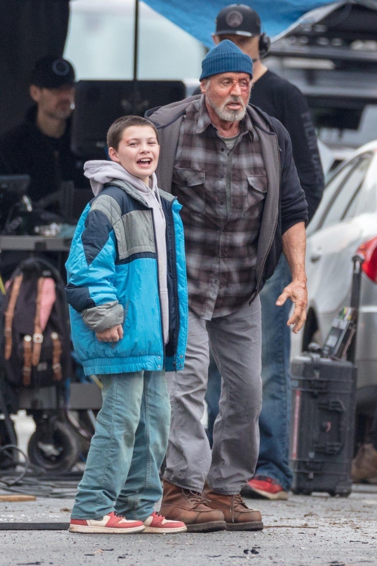 Action star Sylvester Stallone has a face full of blood and bruises as he films dramatic scenes for his upcoming "Samaritan" movie. Stallone, who looks worn out and badly beaten, walks next to Javon "Wanna" Walton, who despite his injuries, shouts in excitement during the scene on Feb. 11, 2020, in Atlanta, Ga.