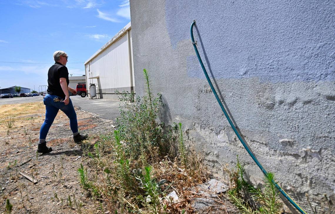 Reedley code enforcement officer Jesalyn Harper walks past the garden hose which tipped her off at the warehouse location which had been illegally operated by Chinese company Prestige Biotech for storage of hazardous materials including illegal COVID-19 and pregnancy tests, lab mice, chemicals and human blood. Photographed Tuesday, August 1, 2023 in Reedley.
