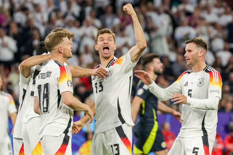 Germany's Thomas Mueller (C) celebrates with teammates during the UEFA Euro 2024 Group A soccer match between Germany and Scotland at Munich Football Arena. Christian Charisius/dpa