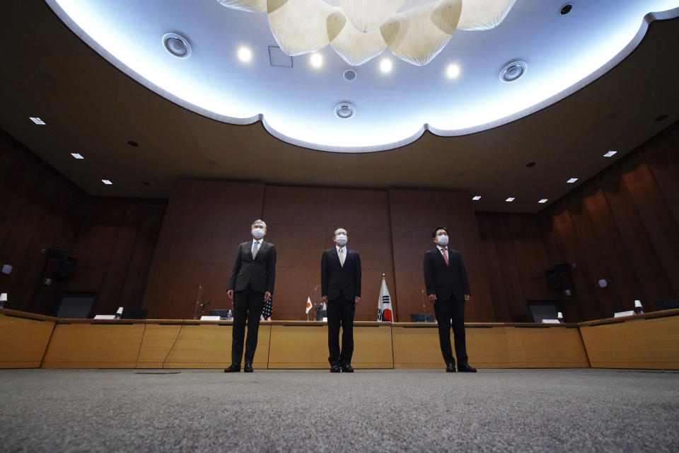 Japanese Foreign Ministry's Director-General of the Asian and Oceanian Affairs Bureau Takehiro Funakoshi, center, U.S. Special Representative for North Korea, Sung Kim, left, and South Korea's Special Representative for Korean Peninsula Peace and Security Affairs Noh Kyu-duk pose for photographers during their trilateral meeting on North Korea at Foreign Ministry Tuesday, Sept. 14, 2021 n Tokyo. (AP Photo/Eugene Hoshiko)