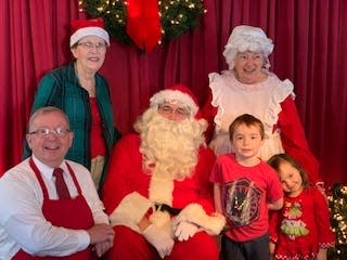 Tom Rice (left) smiles for the camera during Pancakes with Santa, a fundraiser for the Northwest Florida Daily News' Empty Stocking Fund.