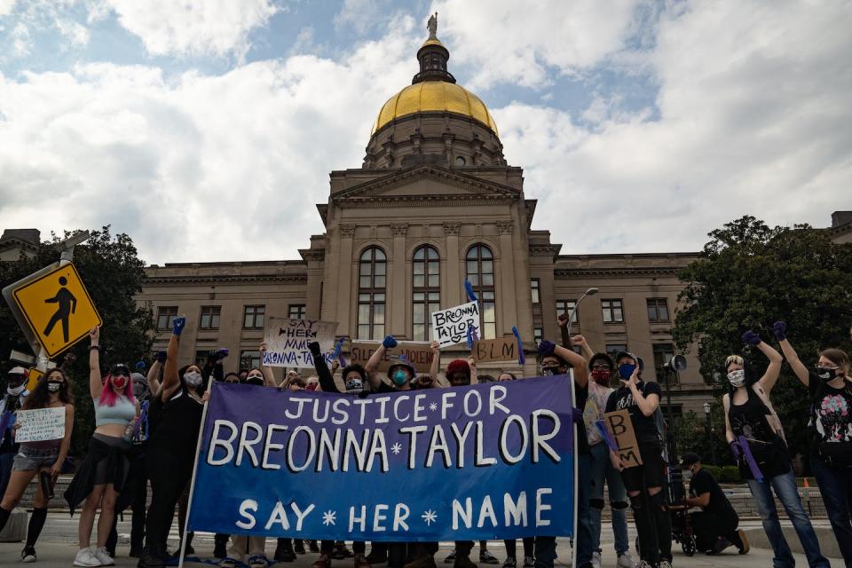 Demonstrators pose in front of the Georgia Capitol building on March 13, 2021, during a march commemorating the one-year anniversary of the police killing of Breonna Taylor in Louisville, Ky. <a href="https://www.gettyimages.com/detail/news-photo/demonstrators-pose-for-a-picture-in-front-of-the-georgia-news-photo/1231697654?adppopup=true" rel="nofollow noopener" target="_blank" data-ylk="slk:Megan Varner/Getty Images;elm:context_link;itc:0;sec:content-canvas" class="link ">Megan Varner/Getty Images</a>