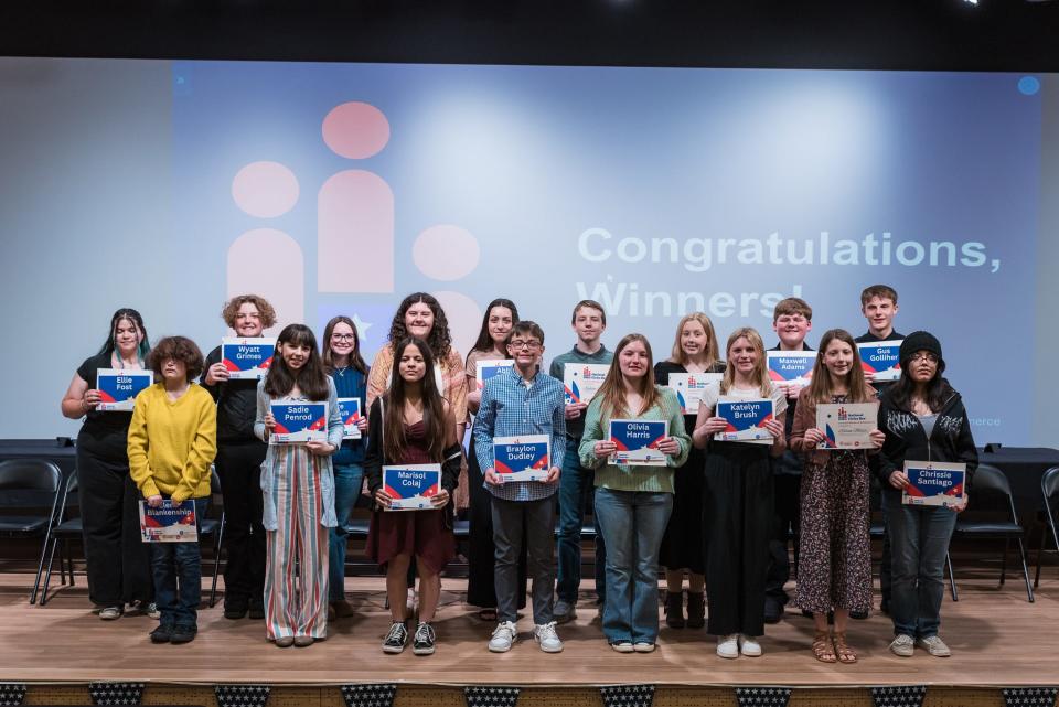 All 17 middle school participants of the Wayne County National Civics Bee, hosted by the Wayne County Area Chamber of Commerce at Indiana University East, pose for a photo on Saturday, April 20, 2024. Ellie Fost (far left) won the competition and will advance to the state competition in August. Sadie Penrod (fourth from left) placed second and Marisol Colaj (right of Penrod) received third place.