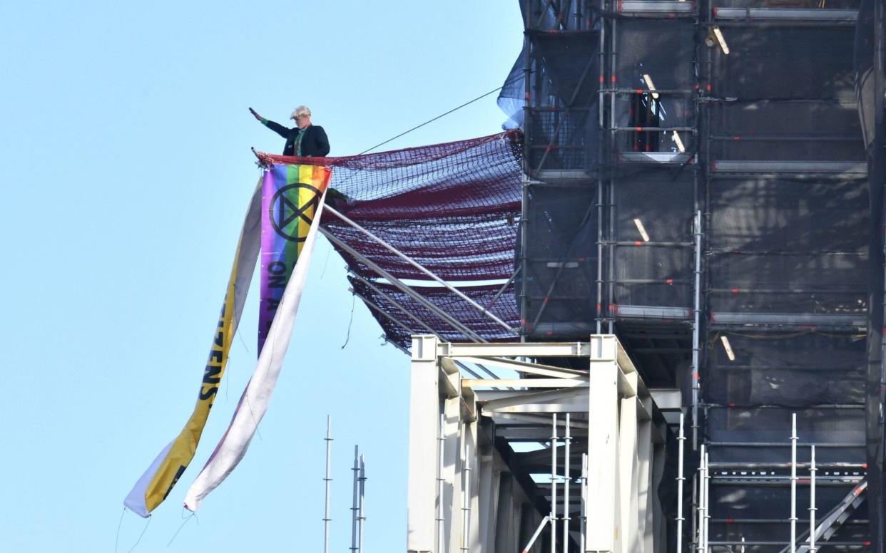 Extinction Rebellion protester scales Big Ben tower dressed as Boris Johnson - PA