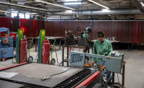 Eric Madrid, a student of Hendry County Adult Learning participating in the welding program, using a bandsaw to cut a plate before he starts his welding assignment on Thursday, March 14 ,2024. The program helps adults gain the necessary experience to receive certification and immediately enter the local workforce after completion in Clewiston, Fla. (AP Photo/Chris Tilley)