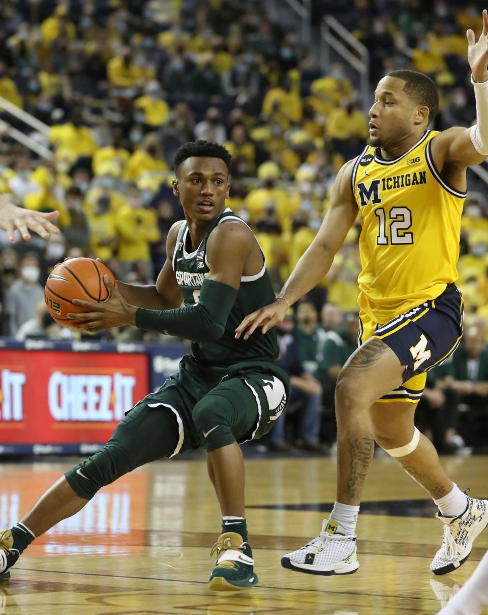 Michigan State guard Tyson Walker drives against Michigan guard DeVante' Jones during the first half on Tuesday, March 1, 2022, at Crisler Center.