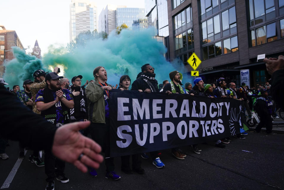 The Emerald City Supporters march to Lumen Field before an MLS playoff soccer match between the Seattle Sounders and FC Dallas, Monday, Oct. 30, 2023, in Seattle. (AP Photo/Lindsey Wasson)