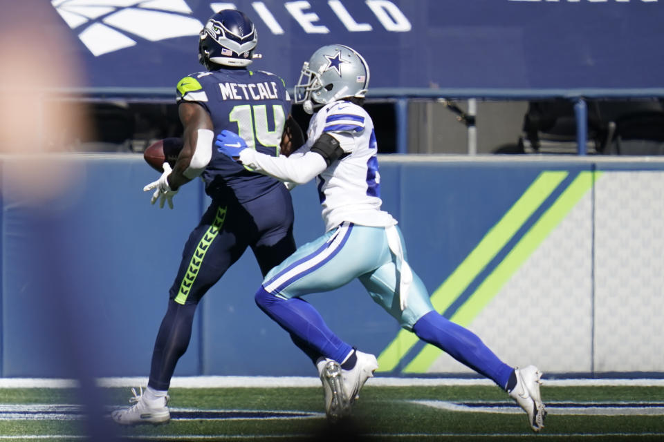 Seattle Seahawks wide receiver DK Metcalf, left, has the ball knocked loose by Dallas Cowboys cornerback Trevon Diggs, right, after catching a pass near the end zone during the first half of an NFL football game, Sunday, Sept. 27, 2020, in Seattle. (AP Photo/Elaine Thompson)