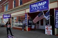 A supporter of U.S. President Donald Trump holds a campaign sign outside the Republican headquarters in Union City, Pennsylvania