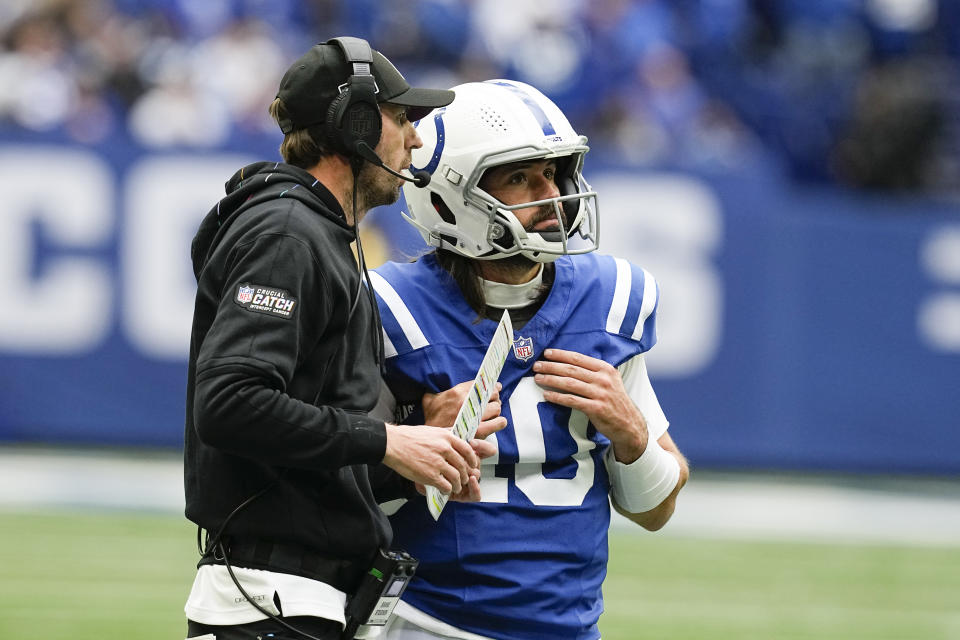 Indianapolis Colts head coach Shane Steichen, left, talks with quarterback Gardner Minshew, right, during a timeout in the second half of an NFL football game against the Tennessee Titans, Sunday, Oct. 8, 2023, in Indianapolis. (AP Photo/Darron Cummings)