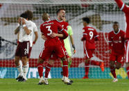 Liverpool's Diogo Jota, centre, is congratulated by teammate Fabinho after scoring his team's third goal during the English Premier League soccer match between Liverpool and Arsenal at Anfield in Liverpool, England, Monday, Sept. 28, 2020. (Jason Cairnduff/Pool via AP)