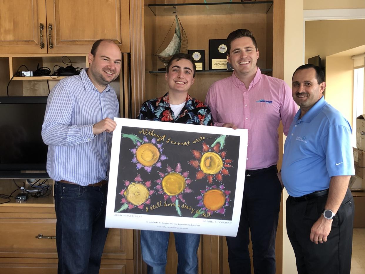 Gabriel Donovan (second from left) holds up his Adirondack Lilly design alongside the men from Spectrum Designs and the Center for Disability Services. (Photo courtesy of Maureen O'Brien)