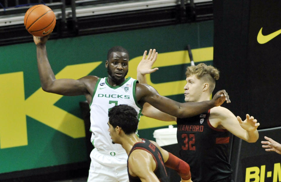 Oregon forward Eugene Omoruyi (2) looks to pass as he is defended by Stanford forward Lukas Kisunas (32) during the first half of an NCAA college basketball game Saturday, Jan. 2, 2021, in Eugene, Ore. (AP Photo/Andy Nelson)