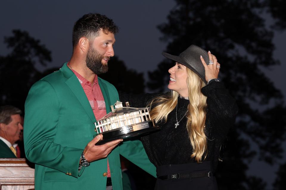 Jon Rahm and Kelley Rahm with the Masters trophy.