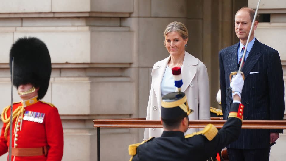 Prince Edward and Sophie, Duchess of Edinburgh react as members of France's Gendarmerie Garde Republicaine take part in a special Changing of the Guard ceremony at Buckingham Palace in London on April 8. - Victoria Jones/Pool/AFP/Getty Images