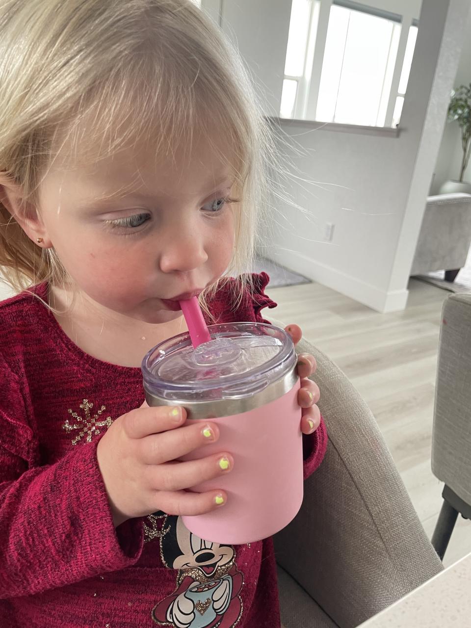 the author's daughter drinking a smoothie