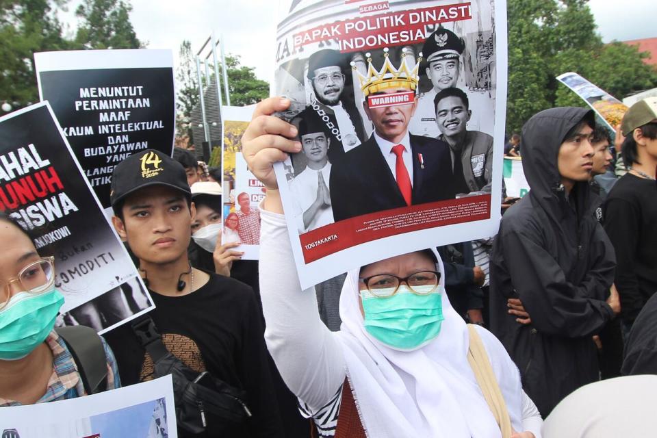 A protester holds up a poster with a defaced image of Indonesian President Joko Widodo during a rally demanding a fair presidential election in Yogyakarta, Indonesia, Monday, Feb. 12, 2024. Student activists staged the rally criticizing Indonesian President Joko Widodo over his lack of neutrality after he threw his support behind presidential frontrunner Prabowo Subianto, who has picked Widodo's son Gibran Rakabuming Raka as his running mate. The presidential election will be held on Feb. 14. 