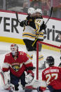 Boston Bruins left wing Taylor Hall (71) and center Pavel Zacha (18) celebrate a goal by Jake DeBrusk (74) during the third period of Game 4 of an NHL hockey Stanley Cup first-round playoff series against the Florida Panthers, Sunday, April 23, 2023, in Sunrise, Fla. The Bruins defeated the Panthers 6-2. Hall and Zacha got an assist on the goal. (AP Photo/Marta Lavandier)