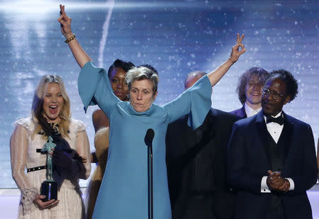 24th Screen Actors Guild Awards – Show – Los Angeles, California, U.S., 21/01/2018 – Frances McDormand (at microphone) celebrates while accompanied by the rest of they cast after they were presented the award for Outstanding Performance by a Cast in a Motion Picture for "Three Billboards Outside Ebbing, Missouri." REUTERS/Mario Anzuoni