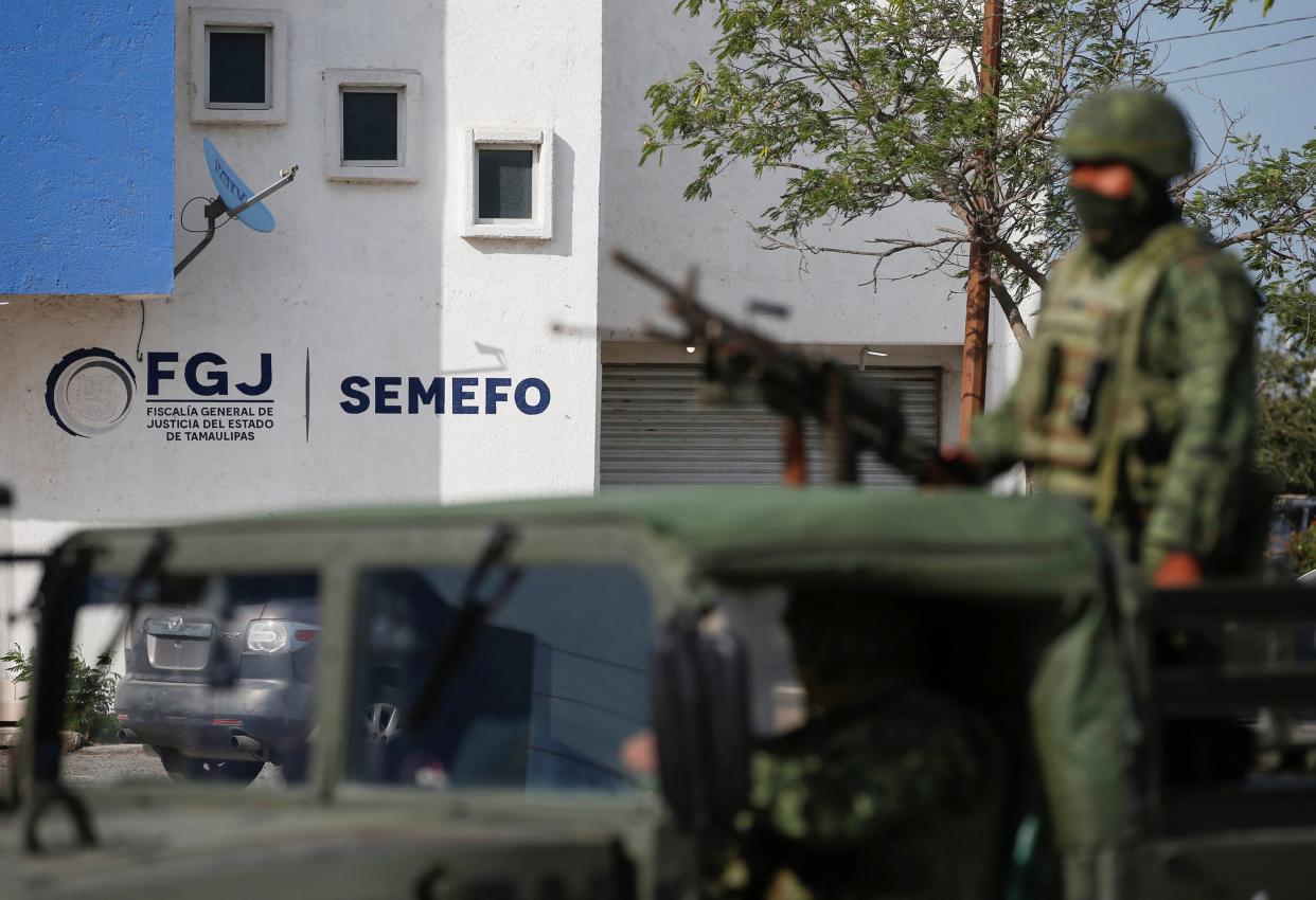 Soldiers stand guard outside the Forensic Medical Service morgue building (REUTERS)