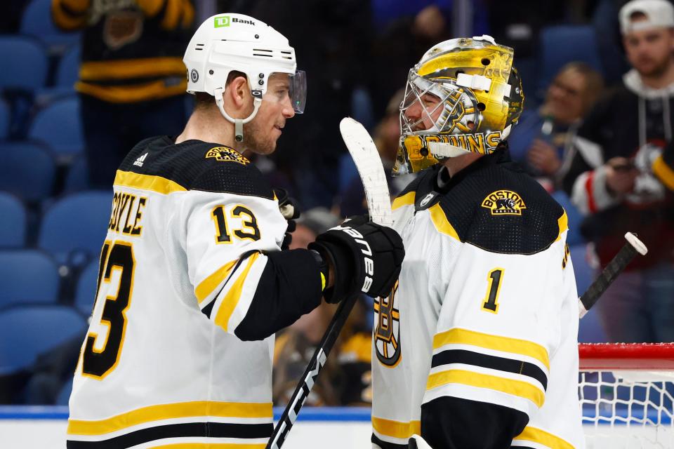 Boston Bruins center Charlie Coyle congratulates goaltender Jeremy Swayman on his second consecutive shutuout.