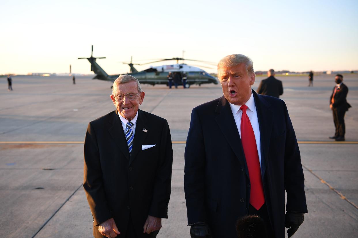 US President Donald Trump speaks with the press alongside former American football player and coach Lou Holtz upon arrival at Pittsburgh International Airport in Pittsburgh, Pennsylvania on October 31, 2020. (Photo by MANDEL NGAN / AFP) (Photo by MANDEL NGAN/AFP via Getty Images)