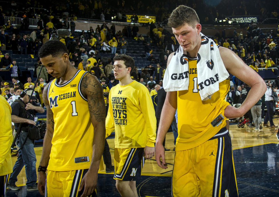 Michigan guard Charles Matthews (1) and center Jon Teske, right, walk off the court after an NCAA college basketball game against Michigan State at Crisler Center in Ann Arbor, Mich., Sunday, Feb. 24, 2019. (AP Photo/Tony Ding)