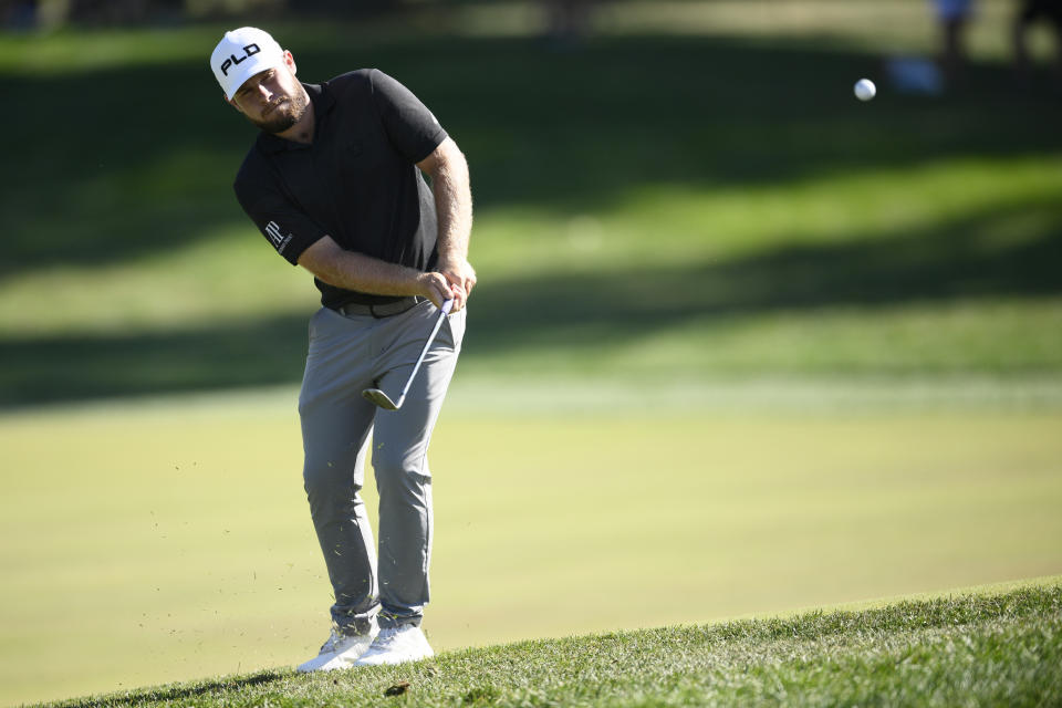 Tyrrell Hatton, of England, chips up to the 18th green during the first round of the BMW Championship golf tournament at Wilmington Country Club, Thursday, Aug. 18, 2022, in Wilmington, Del. (AP Photo/Nick Wass)