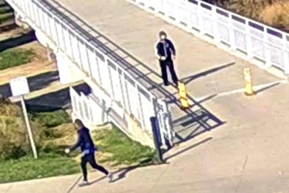 In this surveillance camera image released by the Council Bluffs, Iowa, Police Department, former U.S. Sen. Martha McSally, left, of Arizona, looks back at a man while she was jogging at Tom Hanafan River’s Edge Park on Nov. 8, 2023, in Council Bluffs, Iowa. A man was arrested early Friday, Nov. 10, in the alleged assault of McSally, who says she was molested as she jogged along the Missouri River in Council Bluffs.