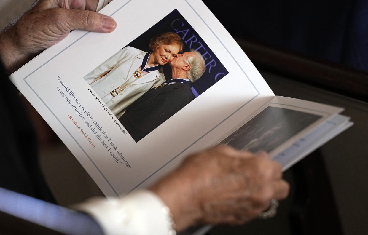 A guest looks at the program prior to a tribute service for former first lady Rosalynn Carter at Glenn Memorial Church on the campus of Emory University in Atlanta on Tuesday. (Brynn Anderson/Pool/AFP via Getty Images)
