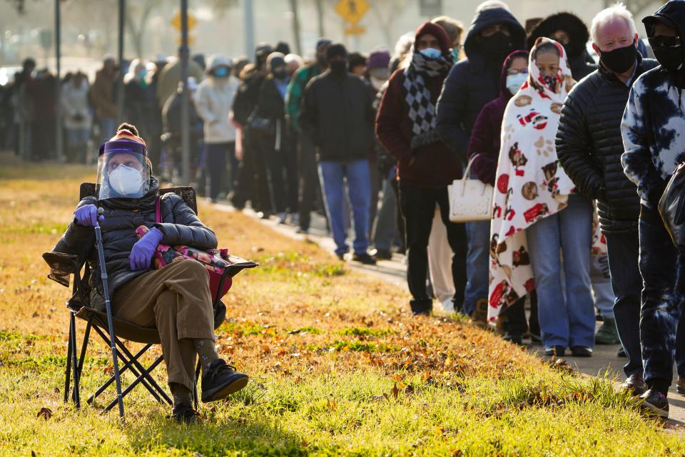 Florence Mullins, 89, sits as a relative holds her place in line to receive a COVID-19 vaccine in Dallas on Jan. 11, 2021.