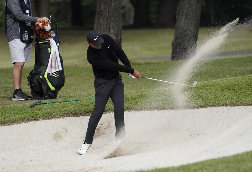 Tiger Woods of the United States hits a shot out of a bunker on the 11th hole during the first round of the Zozo Championship PGA Tour at the Accordia Golf Narashino country club in Inzai, east of Tokyo, Japan, Thursday, Oct. 24, 2019. (AP Photo/Lee Jin-man)