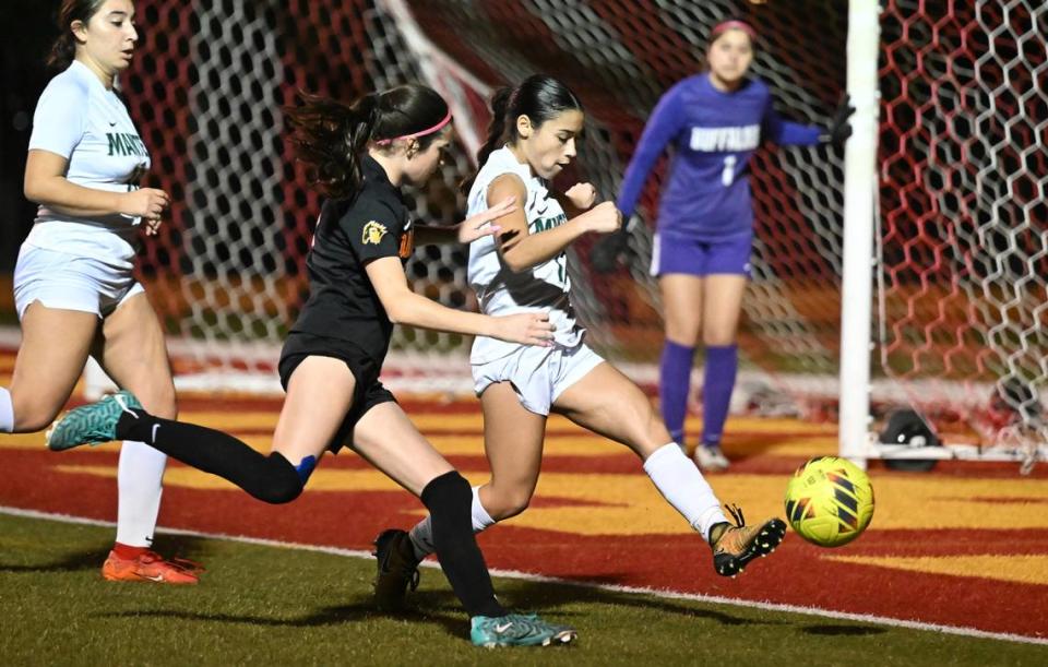 Manteca’s Kailee Jackson clears the ball from the goal box under pressure from Oakdale’s Kyndra Obermeyer and during the Sac-Joaquin Section Division III semifinal game in Oakdale, Calif., Friday, Feb. 16, 2024.