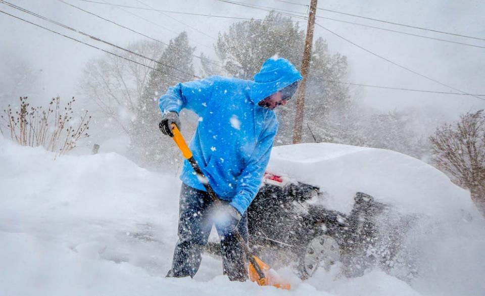 Max Agustin takes the first shift of shoveling at his family's County Road home in Barrington.