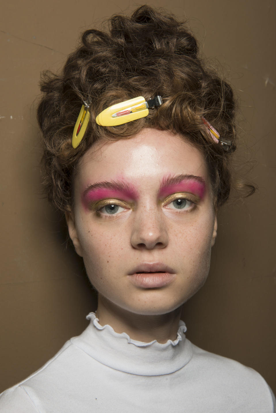 <p>Not on for the wallflowers out there, clashing gold and pink eyeshadow is garish make-up done the right way.</p>