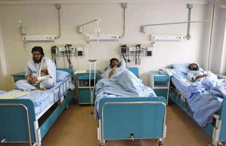 Men receive treatment at a military hospital in Kabul, after being wounded during a suicide attack at a volleyball match on Sunday in the Yahya Khail district of Paktika province, November 24, 2014. REUTERS/Mohammad Ishaq